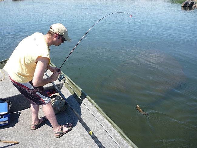 Gary pulls in a smallie.JPG